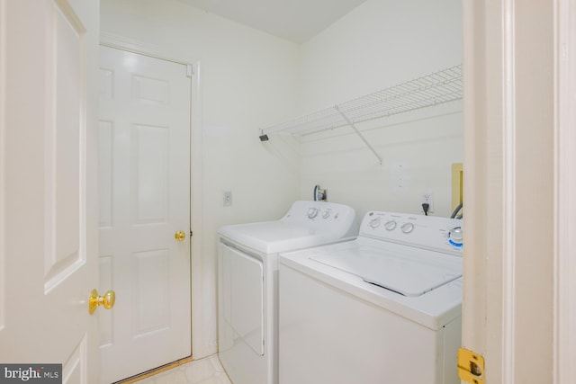 clothes washing area featuring washer and clothes dryer