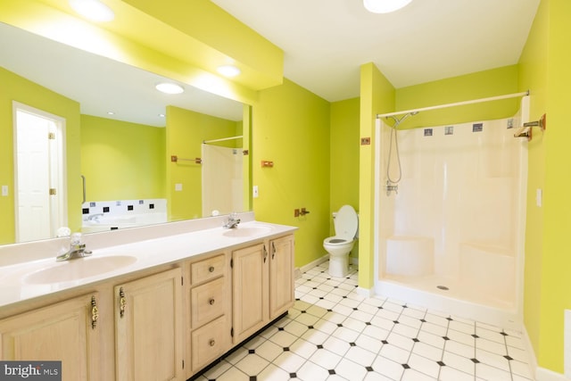 bathroom with a shower, tile patterned floors, vanity, and toilet