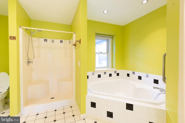 bathroom featuring separate shower and tub and toilet