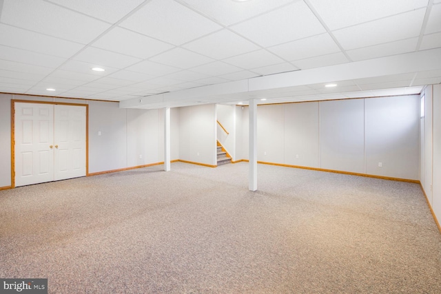 basement with carpet and a drop ceiling