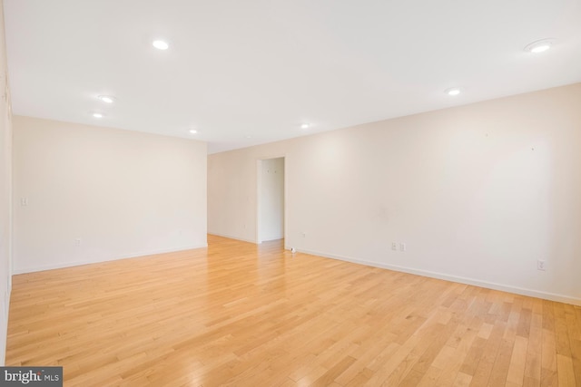 empty room with light hardwood / wood-style flooring