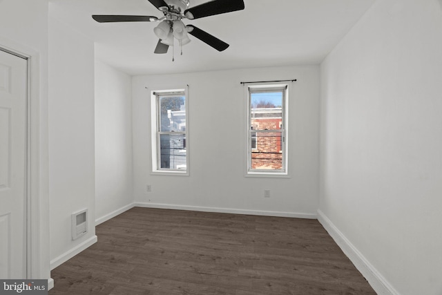 empty room featuring ceiling fan and dark hardwood / wood-style floors