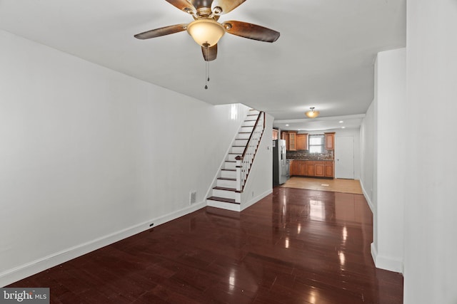 unfurnished living room with ceiling fan and dark hardwood / wood-style floors