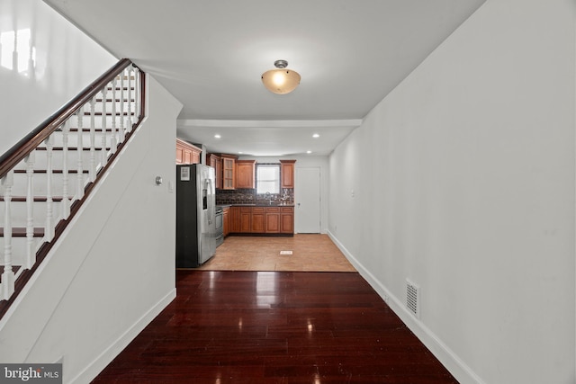 hall featuring hardwood / wood-style floors and sink