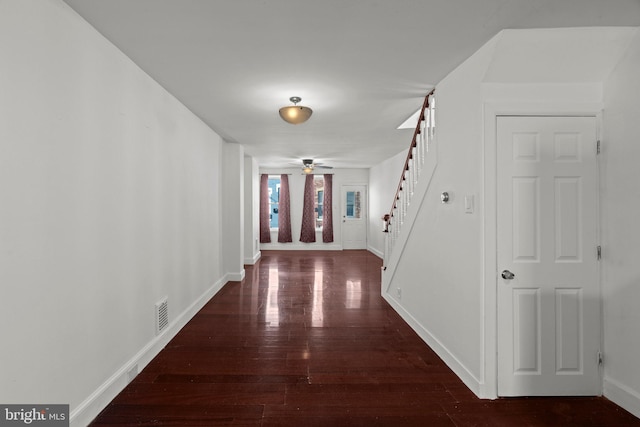 corridor with dark hardwood / wood-style flooring