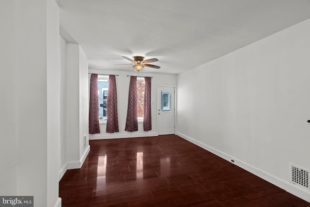 spare room featuring dark hardwood / wood-style floors and ceiling fan