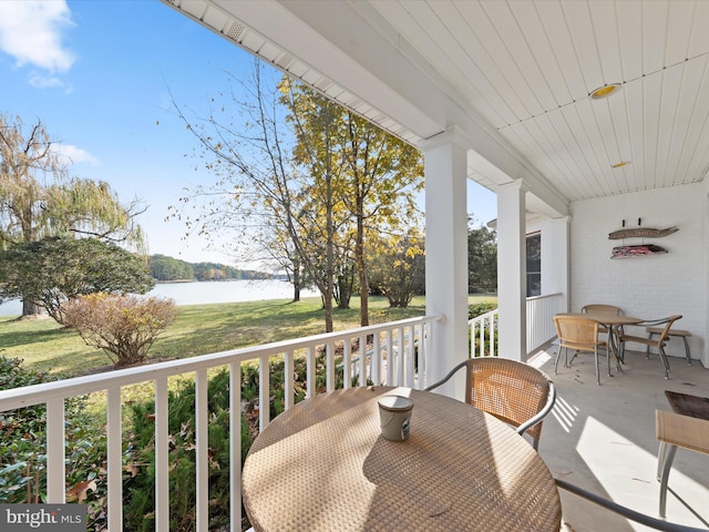 sunroom / solarium featuring a water view