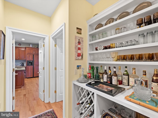 bar featuring light hardwood / wood-style flooring