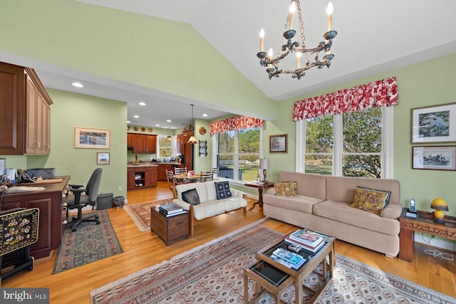 living room with light wood-type flooring, high vaulted ceiling, and an inviting chandelier