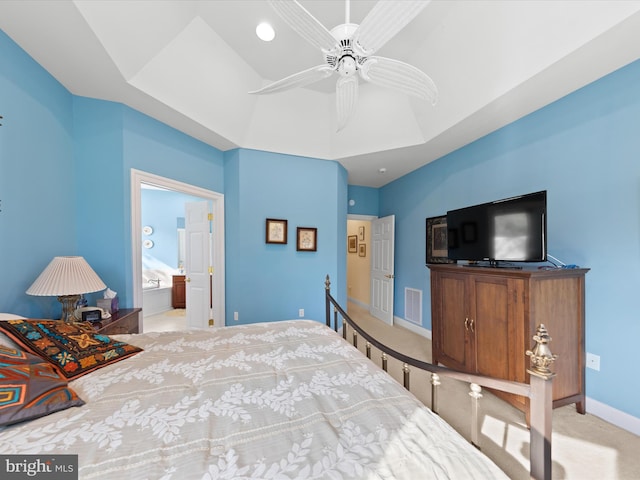 bedroom with light carpet, ensuite bath, and ceiling fan