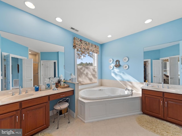 bathroom featuring tile patterned floors, vanity, and shower with separate bathtub