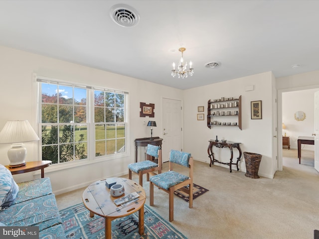 carpeted living room featuring a chandelier