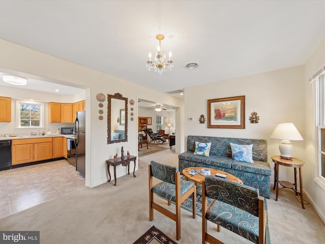 carpeted living room featuring a chandelier and sink