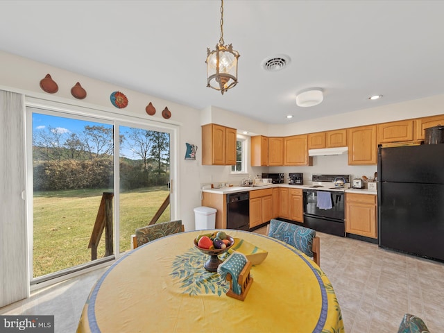 kitchen featuring black appliances, plenty of natural light, pendant lighting, and sink