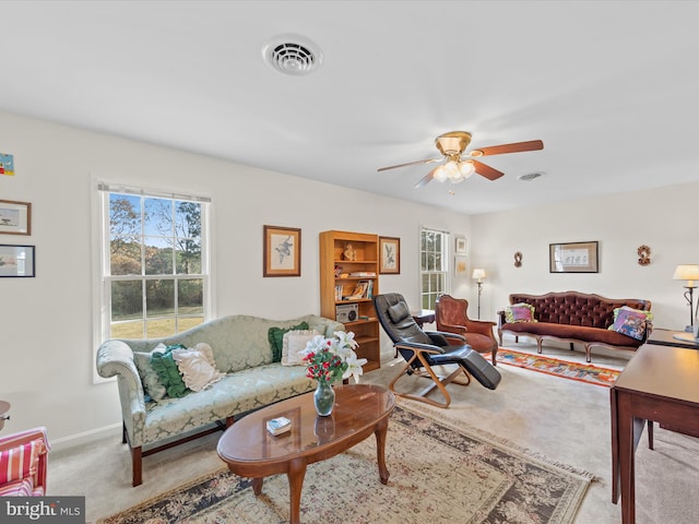 living room with ceiling fan and light colored carpet