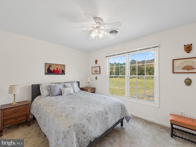 bedroom with ceiling fan and light carpet