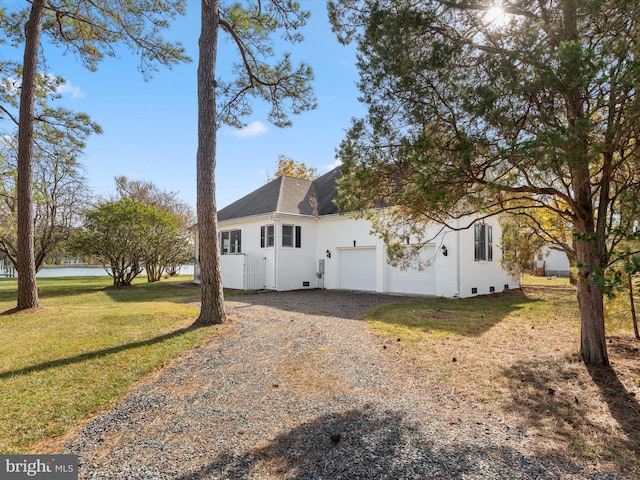 7369 Drum Point Rd, Saint Michaels, MD 21663 - view of property exterior featuring gravel driveway, a lawn, a garage, and roof with shingles