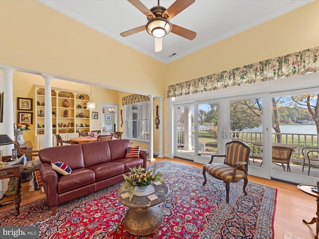 7369 Drum Point Rd, Saint Michaels, MD 21663 - living area with ornamental molding, ceiling fan, decorative columns, wood finished floors, and a water view