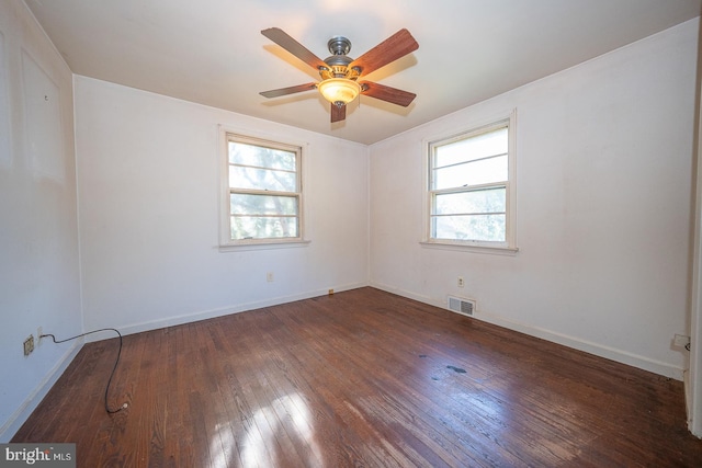 spare room featuring dark hardwood / wood-style floors, a healthy amount of sunlight, and ceiling fan