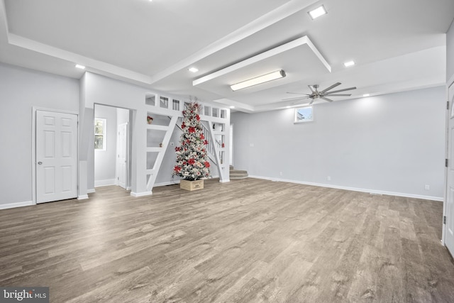 basement featuring ceiling fan and hardwood / wood-style floors