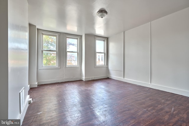 spare room featuring dark hardwood / wood-style flooring