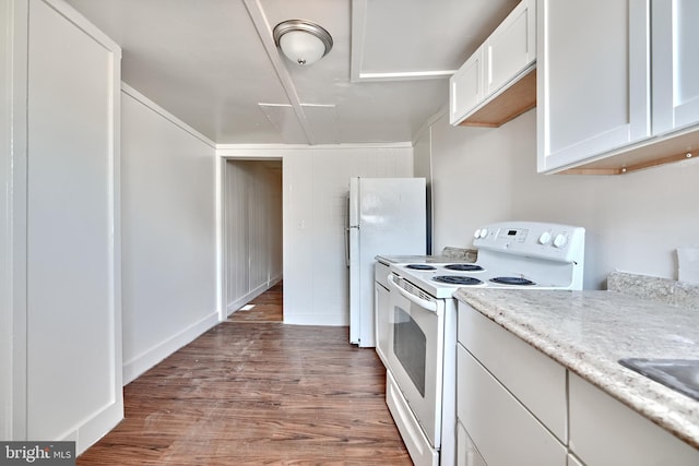 kitchen featuring white appliances, white cabinets, sink, light stone countertops, and dark hardwood / wood-style flooring