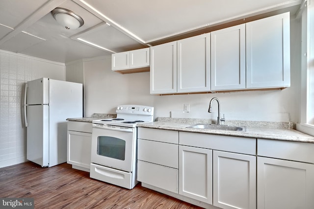 kitchen with white cabinetry, sink, light hardwood / wood-style floors, and white appliances