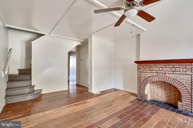 unfurnished living room featuring a fireplace, hardwood / wood-style floors, and ceiling fan