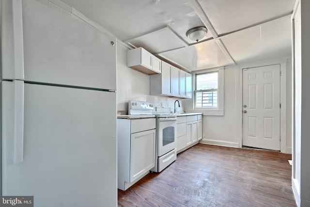 kitchen featuring white appliances, light hardwood / wood-style flooring, white cabinetry, and sink