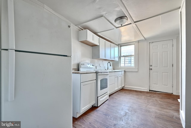 235 N Luzerne Ave N, Baltimore, MD 21224 - kitchen featuring white appliances, wood finished floors, white cabinetry, and a sink