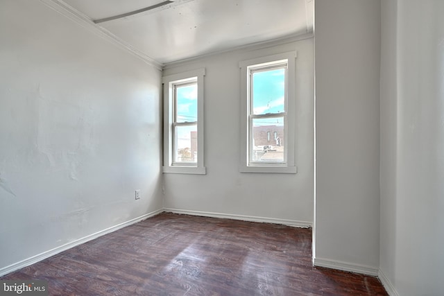 empty room featuring dark hardwood / wood-style floors and ornamental molding