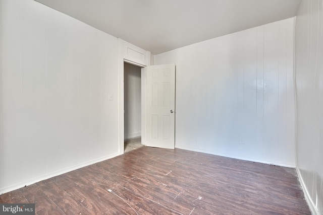 spare room featuring dark hardwood / wood-style flooring