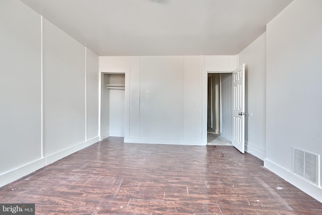 spare room with dark wood-type flooring