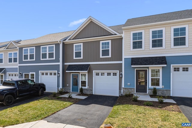 view of property with a front lawn and a garage