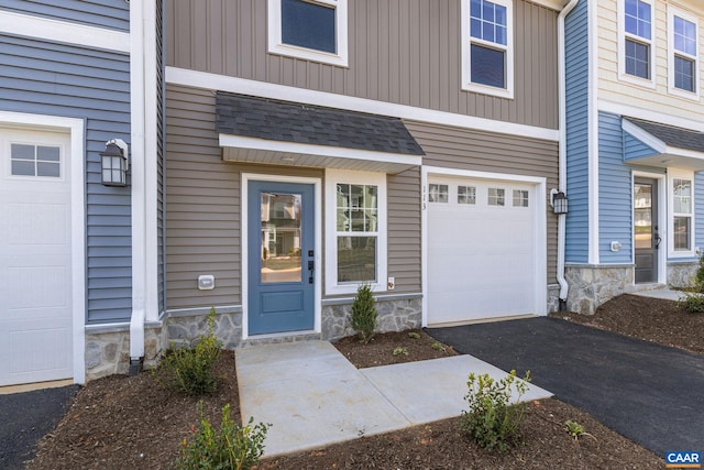 doorway to property with a garage