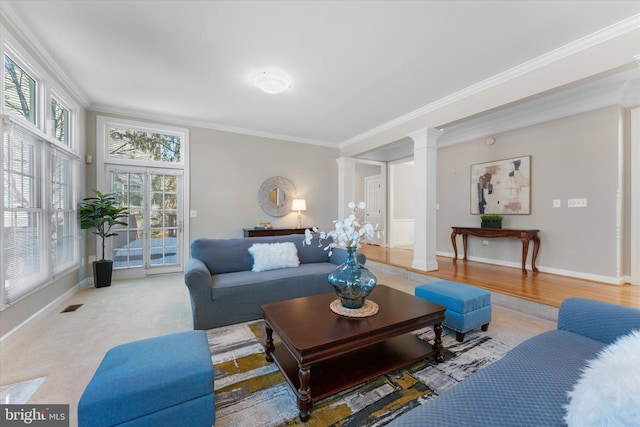 living room featuring crown molding and ornate columns