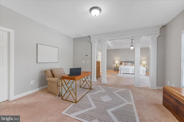 carpeted bedroom with decorative columns