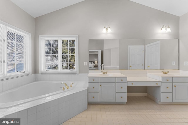 bathroom with lofted ceiling, vanity, a wealth of natural light, and tile patterned floors