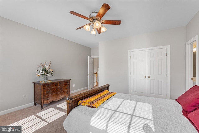 carpeted bedroom featuring ceiling fan and a closet