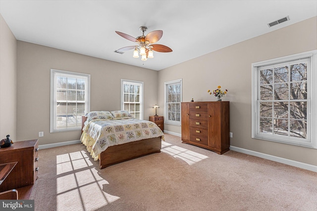 bedroom featuring light colored carpet and ceiling fan