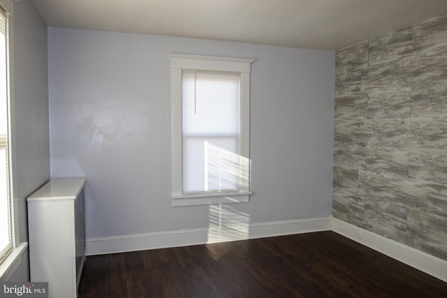 empty room featuring dark wood-type flooring