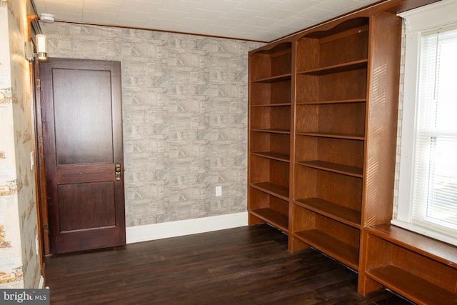 unfurnished room featuring dark hardwood / wood-style flooring and ornamental molding