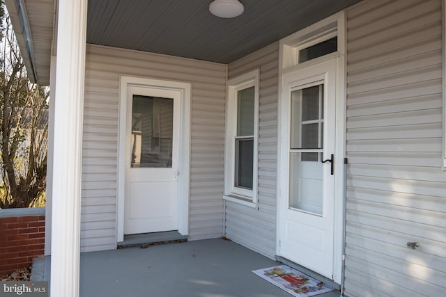 view of exterior entry with covered porch