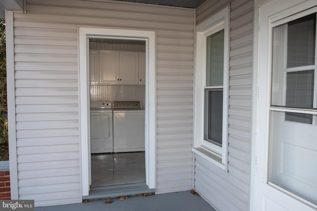 doorway to property with washing machine and dryer and a porch