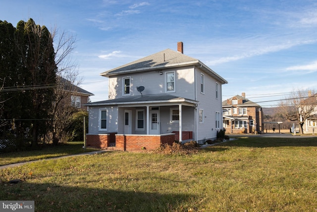 rear view of house featuring a lawn