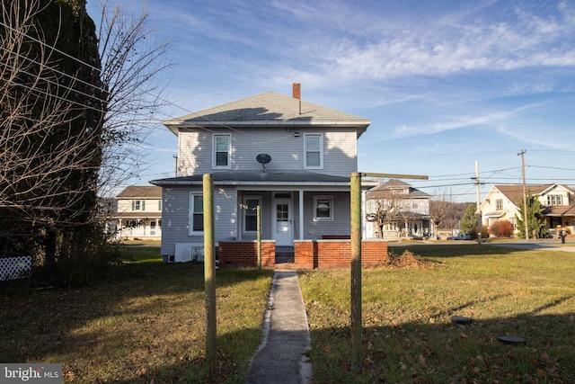 view of front of house featuring covered porch and a front yard