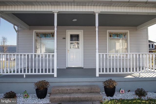 view of exterior entry with covered porch