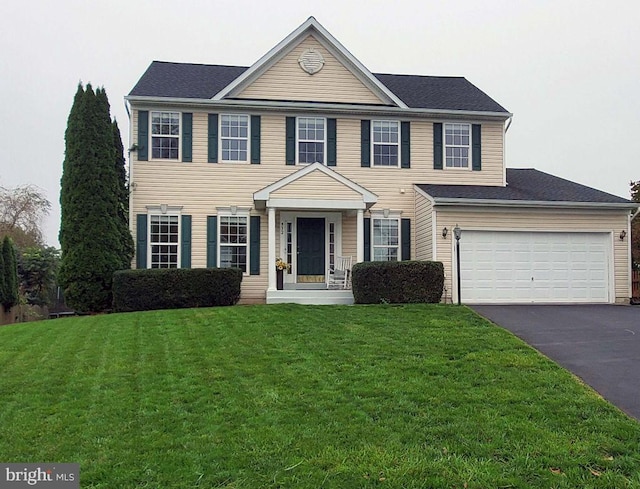 colonial inspired home featuring a front lawn