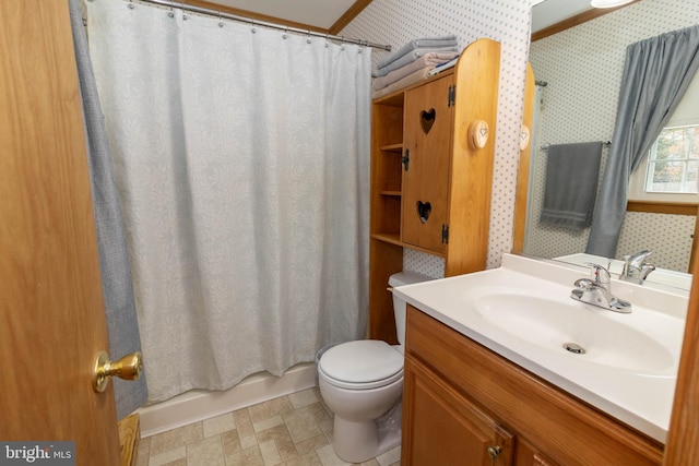 full bathroom featuring vanity, toilet, crown molding, and shower / tub combo