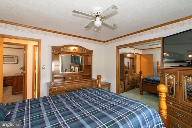 bedroom with ceiling fan, a wall mounted air conditioner, and a textured ceiling